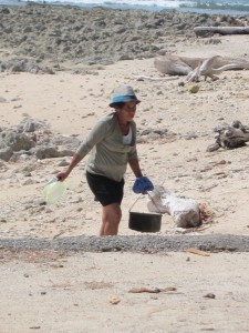 Woman foraging for sea snails in Santa Teresa Costa Rica